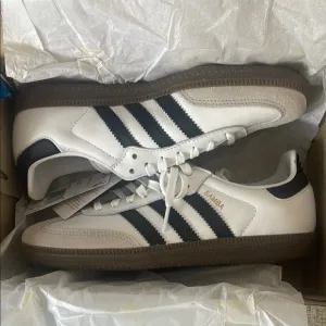 Adidas White and Black Sneakers with Signature Stripes
