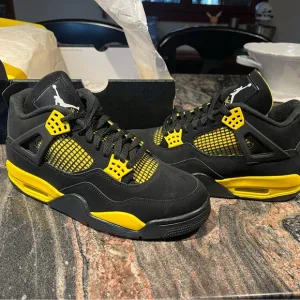 Air Jordan 4 Retro Black and Yellow Thunder Sneakers
