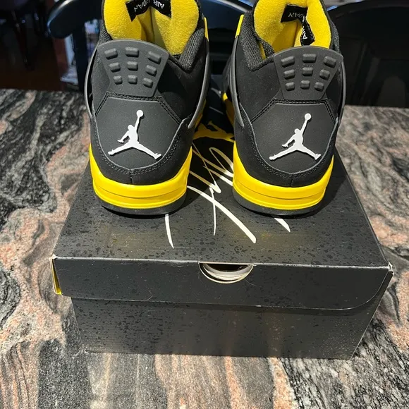 Air Jordan 4 Retro Black and Yellow Thunder Sneakers