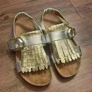 Tory Burch Multi Logo Kiltie Sandals Metallic Gold and Silver Leather